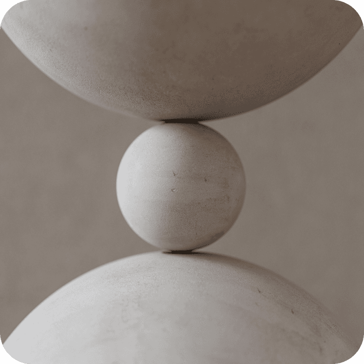 A image of a concrete sphere, balanced between two other larger spheres
